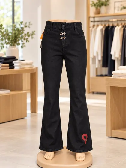 Black flare jeans with metal front details displayed on a mannequin